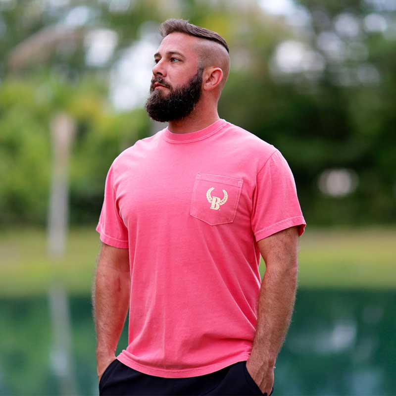 A man with a beard and pink shirt