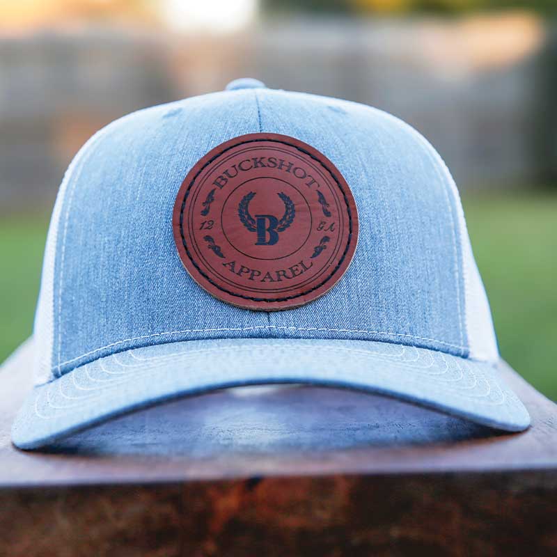 A light blue hat with a leather patch on it's front.