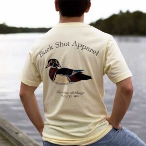 A man standing on the dock wearing a duck shirt.
