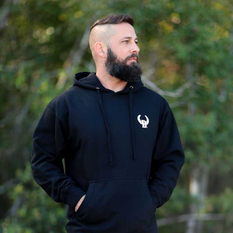 A man with a beard and a black hoodie