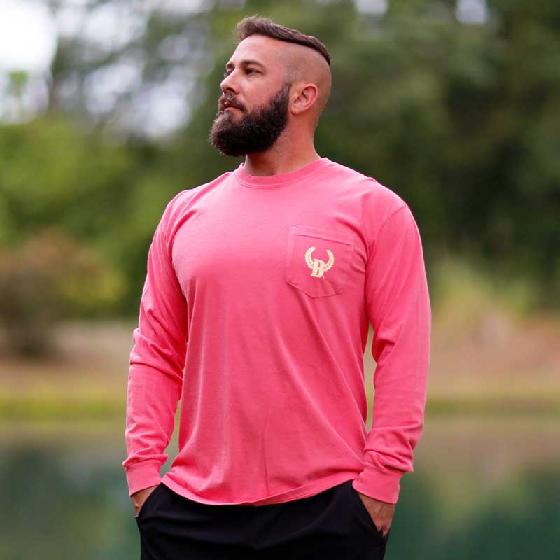 A man with a beard and a pink shirt