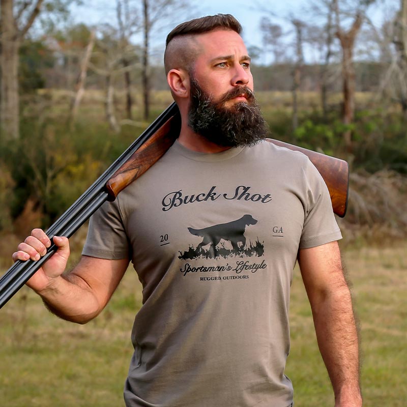 A man with a beard holding a gun