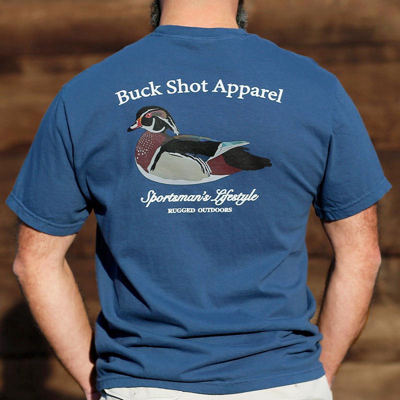 A man wearing a blue shirt with a duck on it.