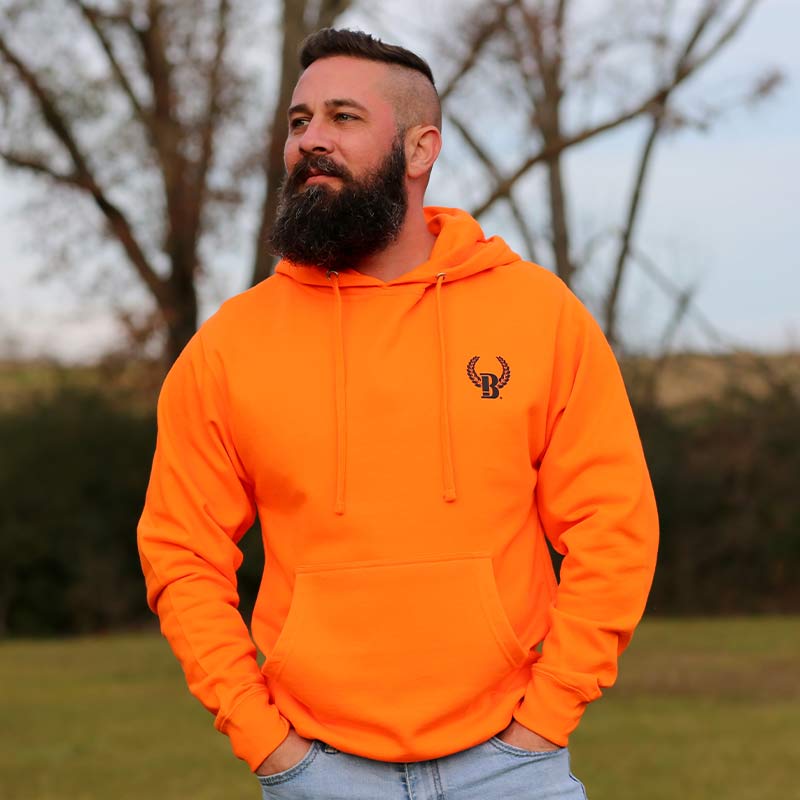 A man with a beard and a bright orange hoodie.