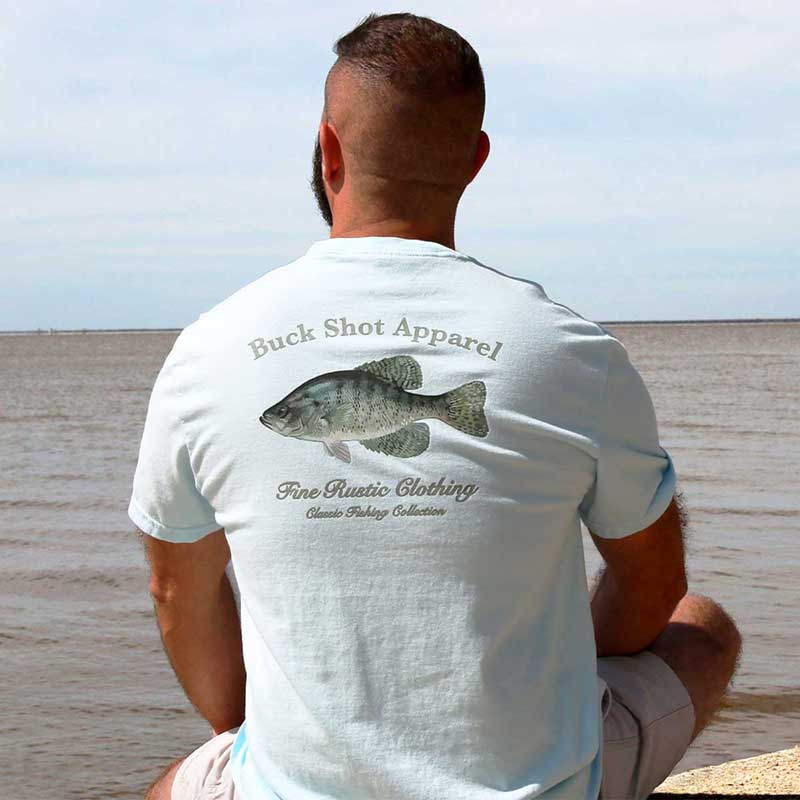 A man sitting on the beach with his back turned to the water.