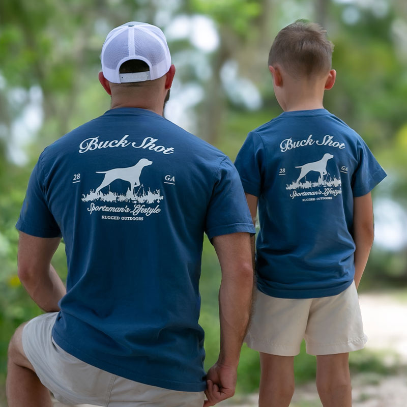 Pointer-father-and-son Father and son wearing matching t-shirts with a silhouette of a pointer standing in grass