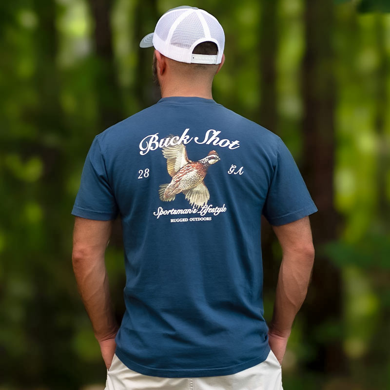 Quial-back-2-web Man wearing a t-shirt with the graphic of a Bobwhite Quail