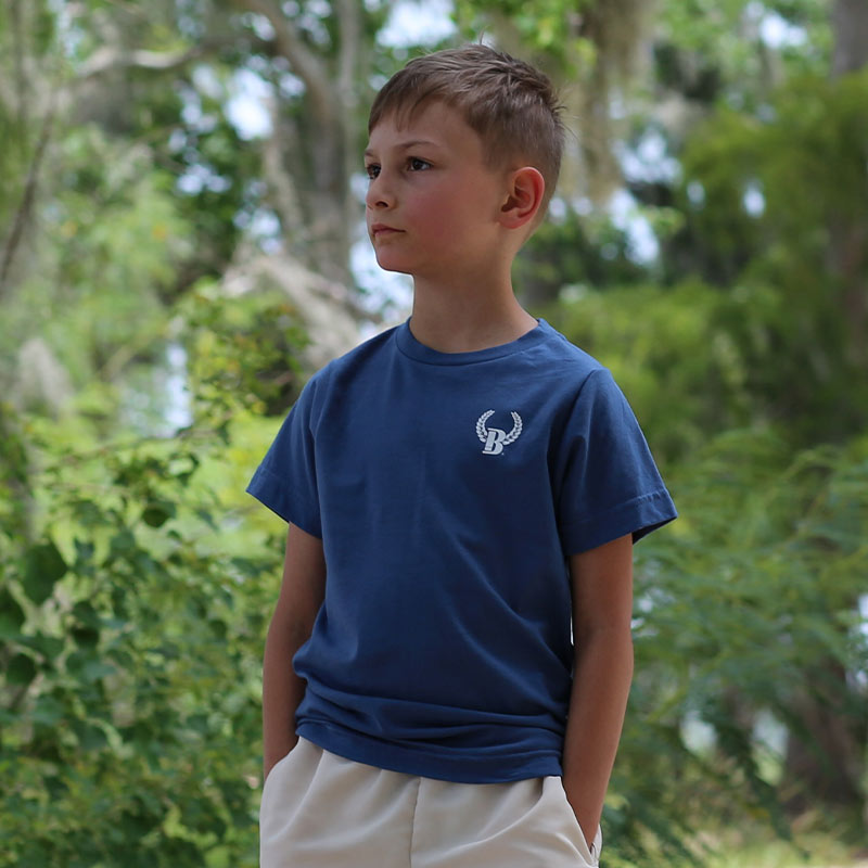 youth indigo blue front Youth wearing a navy t-shirt with a logo on the front left chest
